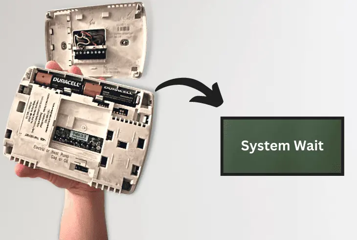 thermostat says system wait after changing batteries